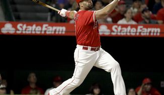 Los Angeles Angels&#x27; Albert Pujols watches his two-run home run against the San Francisco Giants during the sixth inning of a baseball game in Anaheim, Calif., Saturday, April 21, 2018. (AP Photo/Chris Carlson)