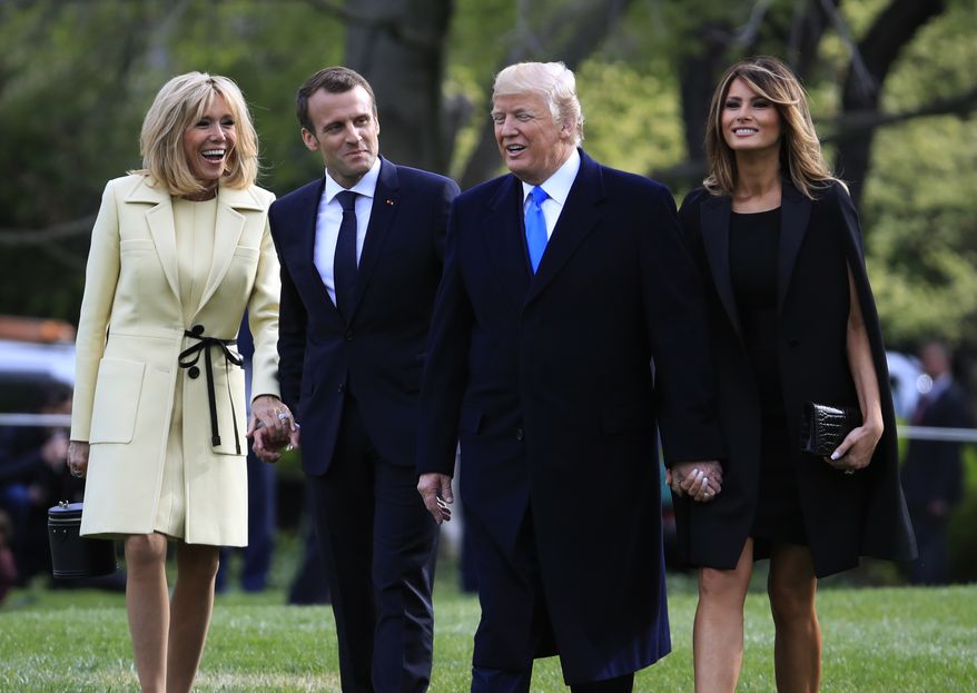 President Donald Trump, first lady Melania Trump, French President Emmanuel Macron and his wife Brigitte Macron, talk as they walk to board a Marine One, following a tree planting ceremony at the White House in Washington, Monday, April 23, 2018. (AP Photo/Manuel Balce Ceneta)