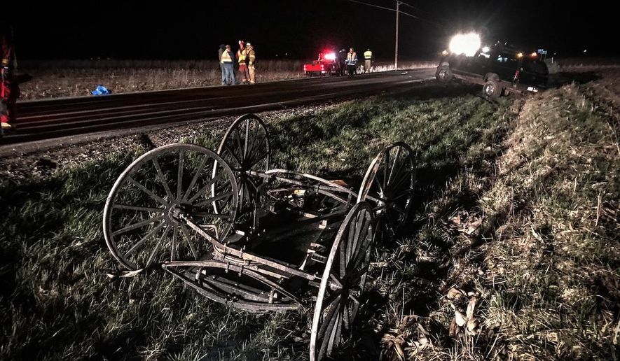 Police investigate the scene where authorities say an Amish buggy has been struck from behind, killing a woman and critically injuring a man and two infants, Friday, April 20, 2018 in Sidney, Ohio. The Shelby County Sheriff's Office says the buggy was properly lit when it was struck around 9 p.m. Friday. Sidney is about 75 miles northwest of Columbus. The driver of the vehicle that struck the buggy fled on foot after the accident and was arrested a mile from the scene. (Jim Noelker/WHIO-TV via AP)