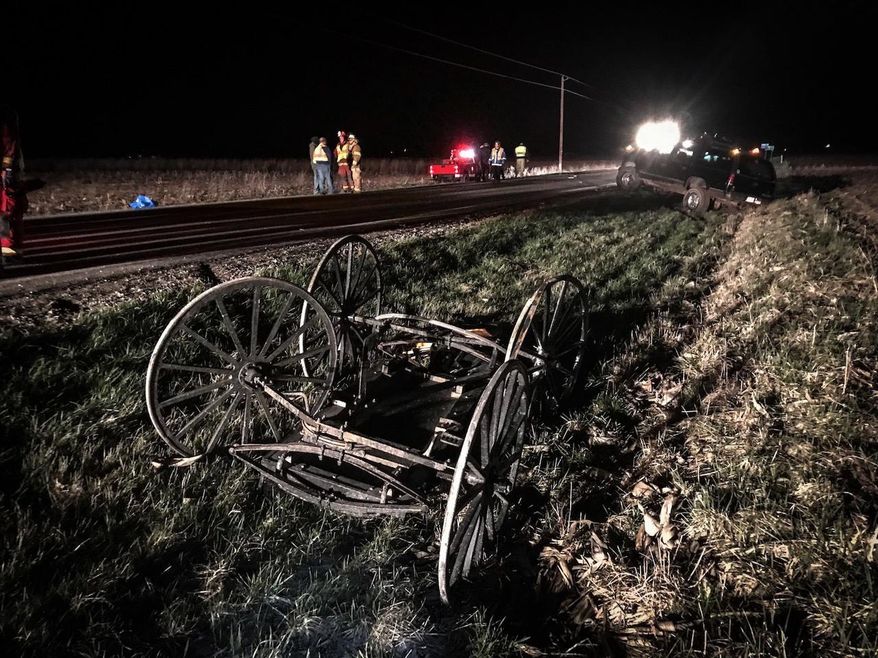 Police investigate the scene where authorities say an Amish buggy has been struck from behind, killing a woman and critically injuring a man and two infants, Friday, April 20, 2018 in Sidney, Ohio. The Shelby County Sheriff's Office says the buggy was properly lit when it was struck around 9 p.m. Friday. Sidney is about 75 miles northwest of Columbus. The driver of the vehicle that struck the buggy fled on foot after the accident and was arrested a mile from the scene. (Jim Noelker/WHIO-TV via AP)