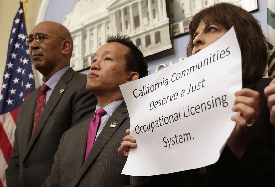 Assemblyman Chris Holden, D-Pasadena, left, and Assemblyman David Chiu, D-San Francisco, center, listen as proponents speak in support of their bills that would generally bar state agencies from denying licenses to an applicant because of prior arrests or convictions for nonviolent offenses, during a news conference, Monday, April 23, 2018, in Sacramento, Calif. Advocates say, that if approved by the Legislature and signed by the governor, the measures could help nearly eight million Californians get licenses so they could work jobs including barbers, cosmetologists, ambulance attendants or providing care to the elderly, ill or those with disabilities. At right is Rebecca Gonzales, of the National Association of Social Workers, who supports that bills. (AP Photo/Rich Pedroncelli)