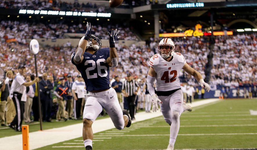 FILE - In this Dec. 3, 2016, file photo, Penn State&#x27;s Saquon Barkley (26) makes an 18-yard touchdown catch against Wisconsin&#x27;s T.J. Watt (42) during the second half of the Big Ten championship NCAA college football game, in Indianapolis. Despite the screams from Big Blue fans to find the replacement for Eli Manning, the Giants believe he has two or three very good years left. Helping Manning recapture the glory will be the highest-rated player in the entire draft. (AP Photo/AJ Mast, File)