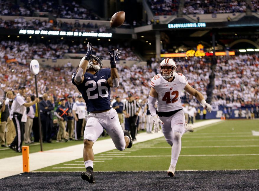 FILE - In this Dec. 3, 2016, file photo, Penn State's Saquon Barkley (26) makes an 18-yard touchdown catch against Wisconsin's T.J. Watt (42) during the second half of the Big Ten championship NCAA college football game, in Indianapolis. Despite the screams from Big Blue fans to find the replacement for Eli Manning, the Giants believe he has two or three very good years left. Helping Manning recapture the glory will be the highest-rated player in the entire draft. (AP Photo/AJ Mast, File)