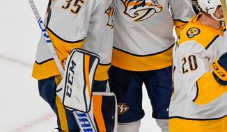 Nashville Predators goaltender Pekka Rinne (35) and Mike Fisher (12) celebrate a 5-0 series-winning victory against the Colorado Avalanche during Game 6 of an NHL hockey first-round playoff series, Sunday, April 22, 2018, in Denver. (AP Photo/Jack Dempsey)
