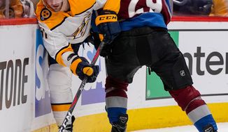 Nashville Predators left wing Austin Watson (51) slips past Colorado Avalanche center Nathan MacKinnon (29) during the second period in Game 6 of an NHL hockey first-round playoff series Sunday, April 22, 2018, in Denver. (AP Photo/Jack Dempsey)