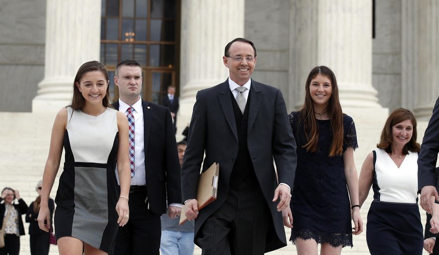 Deputy Attorney General Rod J. Rosenstein departs the Supreme Court on Monday, April 23, 2018, in Washington, with his family, after arguing his first case before the court. He was defending the government's position in a case involving the prison sentence for a convicted drug dealer. (AP Photo/Alex Brandon)