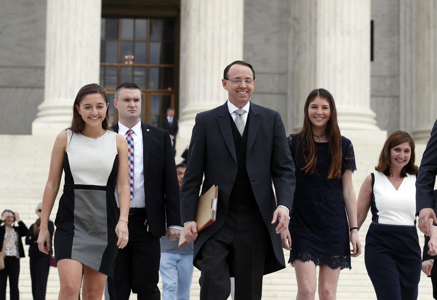 Deputy Attorney General Rod J. Rosenstein departs the Supreme Court on Monday, April 23, 2018, in Washington, with his family, after arguing his first case before the court. He was defending the government's position in a case involving the prison sentence for a convicted drug dealer. (AP Photo/Alex Brandon)