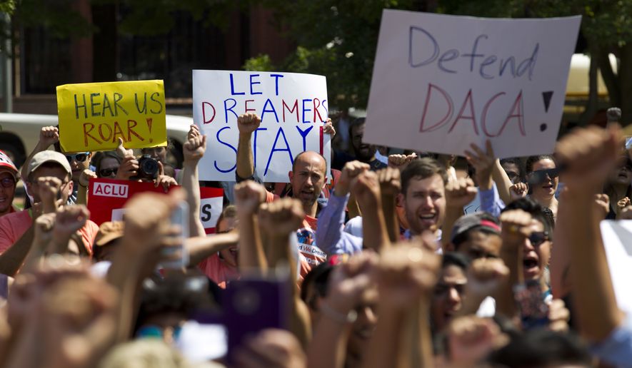 Protesters hold up signs during a rally supporting Deferred Action for Childhood Arrivals, or DACA, outside of the White House in Washington, on Tuesday, Sept. 5, 2017. (AP Photo/Jose Luis Magana) ** FILE **