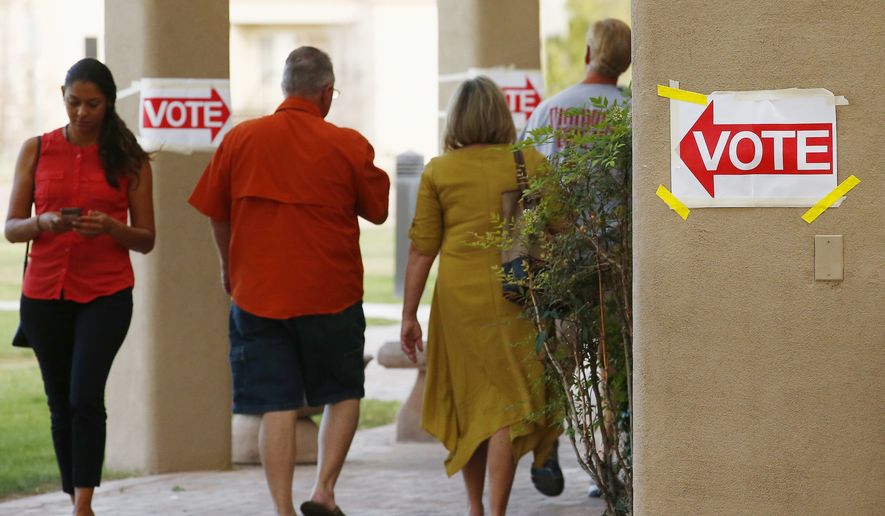 Voters arrive and depart a polling station in Arizona in this April 24, 2018 file photo. (AP Photo/Ross D. Franklin) **FILE**