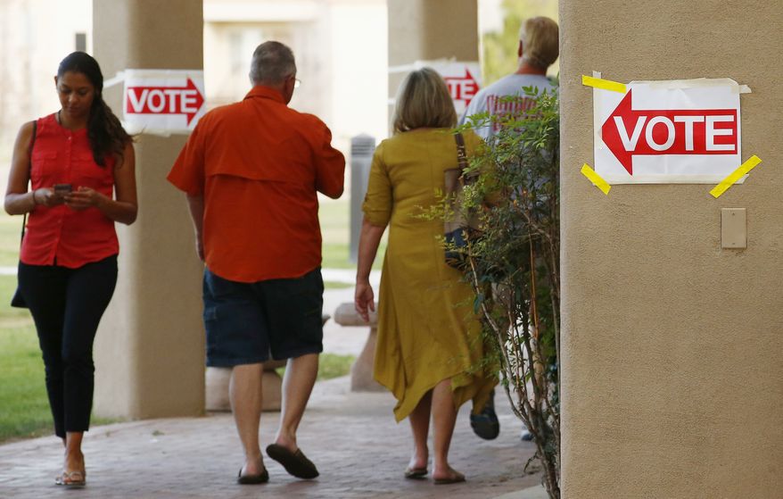 Voters arrive and depart a polling station in Arizona in this April 24, 2018 file photo. (AP Photo/Ross D. Franklin) **FILE**
