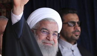 In this photo released by official website of the office of the Iranian Presidency, President Hassan Rouhani waves to the crowd in a public gathering during his visit to the northwestern city of Tabriz, Iran, Tuesday, April 24, 2018. Iran&#x27;s president reiterated his warning against a U.S. pullout from the landmark nuclear deal between Tehran and world powers as meetings between President Donald Trump France&#x27;s Emmanuel Macron got underway in Washington. (Iranian Presidency Office via AP)