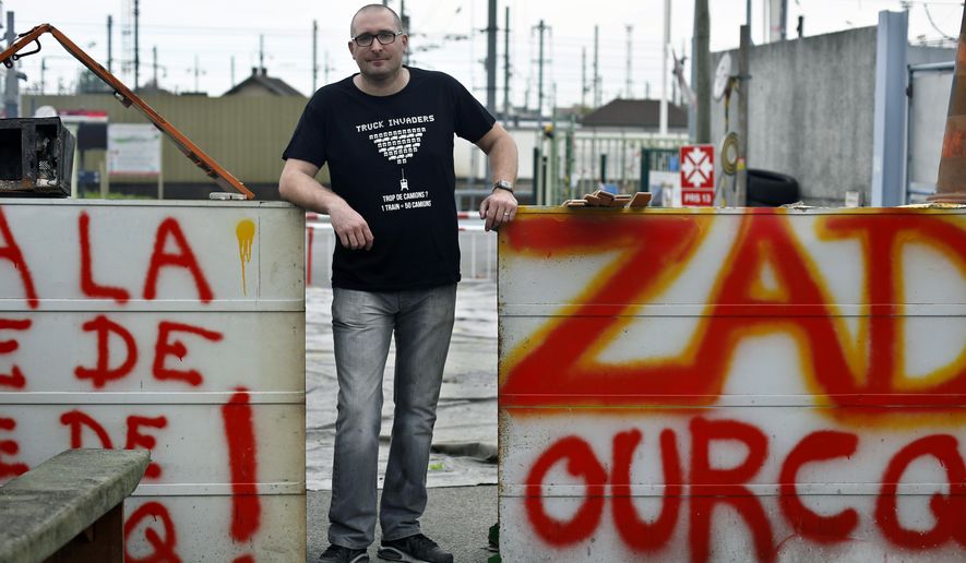 Train worker Jonathan Seigneur poses during a picket line, in Pantin, north of Paris, Monday, April 23, 2018. Seigneur fixes trains for a modest salary that he accepted in exchange for job security. And now he is on strike along with thousands of other workers at national railway SNCF, to protest Macron&#x27;s reforms to the rail sector and to protect the idea of public service _ and the French way of life. (AP Photo/Thibault Camus)
