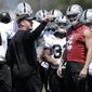 Oakland Raiders coach Jon Gruden, center left, talks with quarterback Derek Carr (4) and offensive players at the NFL football team&#x27;s facility in Alameda, Calif., Tuesday, April 24, 2018. (AP Photo/Jeff Chiu)