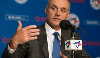 Baseball Commissioner Rob Manfred takes questions from the media before a game between the Boston Red Sox and the Toronto Blue Jays in Toronto on Tuesday, April 24, 2018. (Fred Thornhill/The Canadian Press via AP)