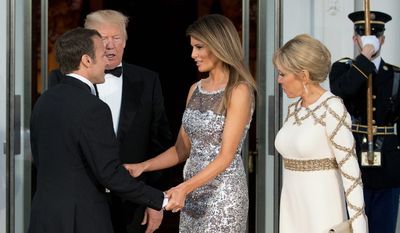 President Donald Trump and first lady Melania Trump greet French President Emmanuel Macron and his wife Brigitte Macron as they arrive for a State Dinner at the White House.