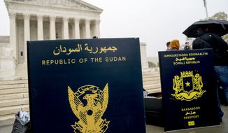 Poster sized enlargements of passports are on display during an anti-Muslim ban rally as the Supreme Court hears arguments about wether President Donald Trump&#39;s ban on travelers from several mostly Muslim countries violates immigration law or the Constitution, Wednesday, April 25, 2018, in Washington. (AP Photo/Andrew Harnik)