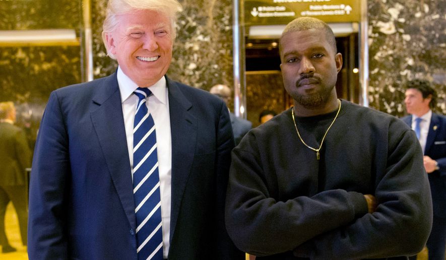 FILE - In this Dec. 13, 2016, file photo, then-President-elect Donald Trump and Kanye West pose for a picture in the lobby of Trump Tower in New York. Trump is tweeting his thanks to rap superstar Kanye West for his recent online support. Trump wrote, “Thank you Kanye, very cool!” in response to the tweets from West, who called the president “my brother.” West tweeted a number of times Wednesday expressing his admiration for Trump, saying they both share “dragon energy.” The rap star also posted a photo of himself wearing Trump’s campaign “Make America Great Again” hat. (AP Photo/Seth Wenig, File)