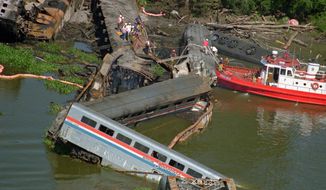 FILE - This Sept. 22, 1993, file photo shows the wreckage of the Amtrak Sunset Limited train, north of Mobile, Ala. A barge hit a railroad bridge and minutes later the train hit the bent tracks and plunged into the bayou, killing 47 people and injuring more than 100 others. A string of crashes involving Amtrak trains is rekindling memories for survivors of the passenger service’s 1993 tragedy, its deadliest accident ever. (AP Photo/Mark Foley, File)