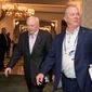 FILE - In this March 28, 2018, file photo, Dallas Cowboys owner Jerry Jones, left, and director of player personnel Stephen Jones leave a conference room during the NFL owners meetings in Orlando, Fla. With Dez Bryant gone, the Dallas Cowboys have to decide if they will use their top pick on a receiver for the first time since taking him eight years ago.  The answer on going that high to get another target for quarterback Dak Prescott, as it was before Bryant’s release this month, is an emphatic “maybe.” (Phelan M. Ebenhack/AP Images for NFL, File)