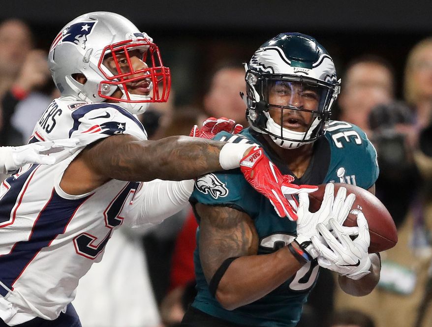 FILE - In this Feb. 4, 2018, file photo, Philadelphia Eagles' Corey Clement, right, catches a touchdown pass in front of New England Patriots' Marquis Flowers during the second half of the NFL Super Bowl 52 football game in Minneapolis. While first-round picks receive most of the attention and players chosen the first two days of the draft get more money and better job security, success on Day 3 of the draft often separates the elite teams from the good ones. That was evident when the Eagles and Patriots met in February. Corey Clement had 100 yards receiving and one touchdown and LeGarrette Blount ran for 90 yards and one touchdown in Philadelphia's 41-33 victory. Danny Amendola led the Patriots with 152 yards receiving and Chris Hogan had 128. All four players were undrafted free agents. (AP Photo/Jeff Roberson, File)