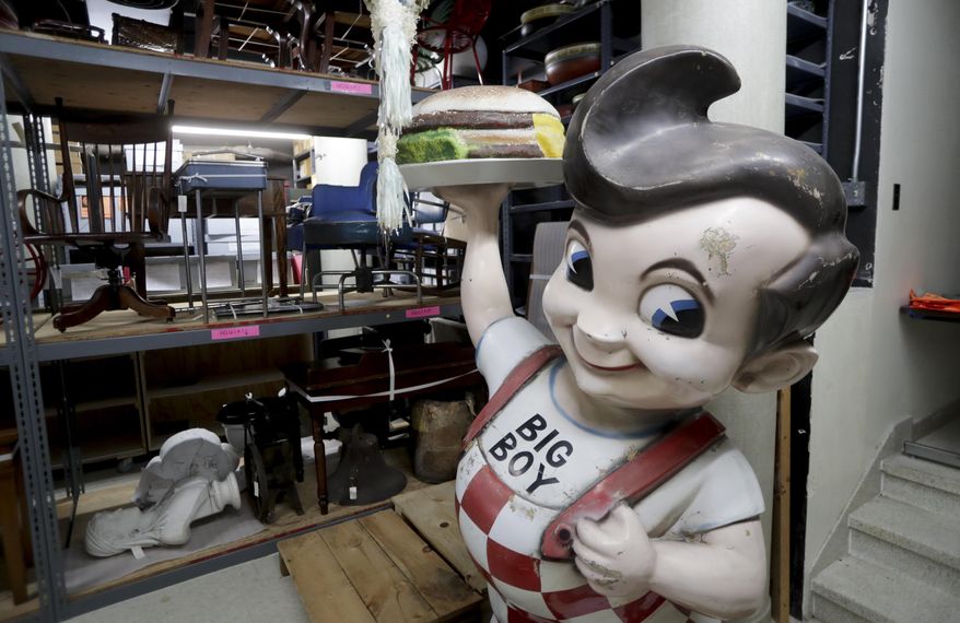 In this Thursday, April 19, 2018 photo, a Big Boy statue from the restaurant chain popular in the 1970s and 1980s and other items sits in the basement of the Wisconsin Historical Society's headquarters in Madison, Wis. Construction of the $46 million State Archive Preservation Facility is complete but now the task of moving artifacts to the facility is underway. The effort is expected to take up to 18 months. (Steve Apps/Wisconsin State Journal via AP)