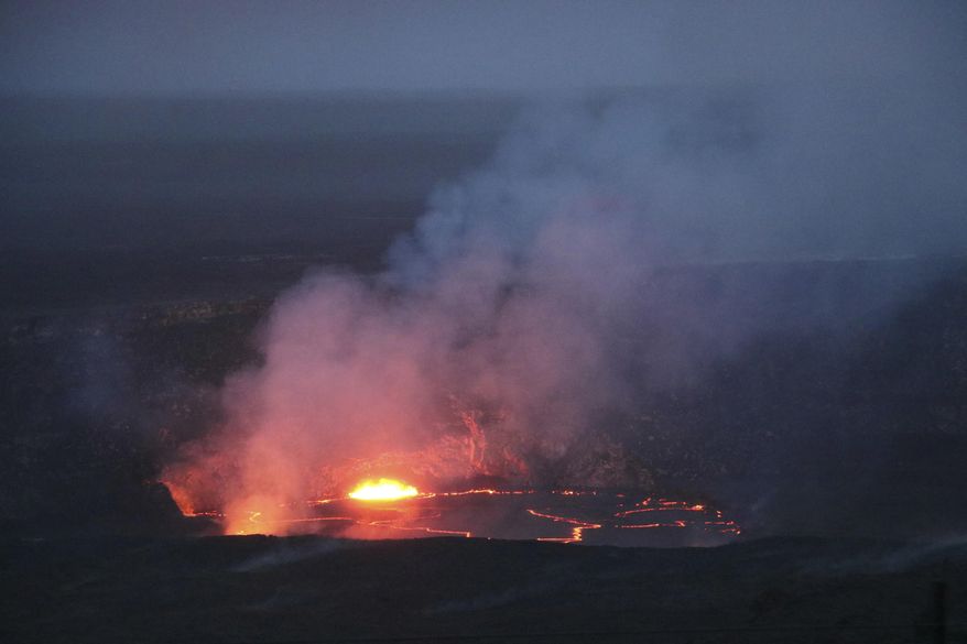 In this April 21, 2018 photo provided by the U.S. Geological Survey, the slowly rising lava lake at Kilauea's summit is shown very close the floor of Halemaumau Crater in Hawaii Volcanoes National Park on Hawaii's Big Island. Lava from Kilauea's summit lava lake continues to overflow intermittently out of its Overlook crater onto the floor of Halemaumau Crater, after recording its largest overflow since the summit vent opened up 10 years ago. Hawaiian Volcano Observatory scientists noted overflows again Wednesday morning around 8:30 a.m., after two episodes of activity Tuesday. (U.S. Geological Survey via AP)