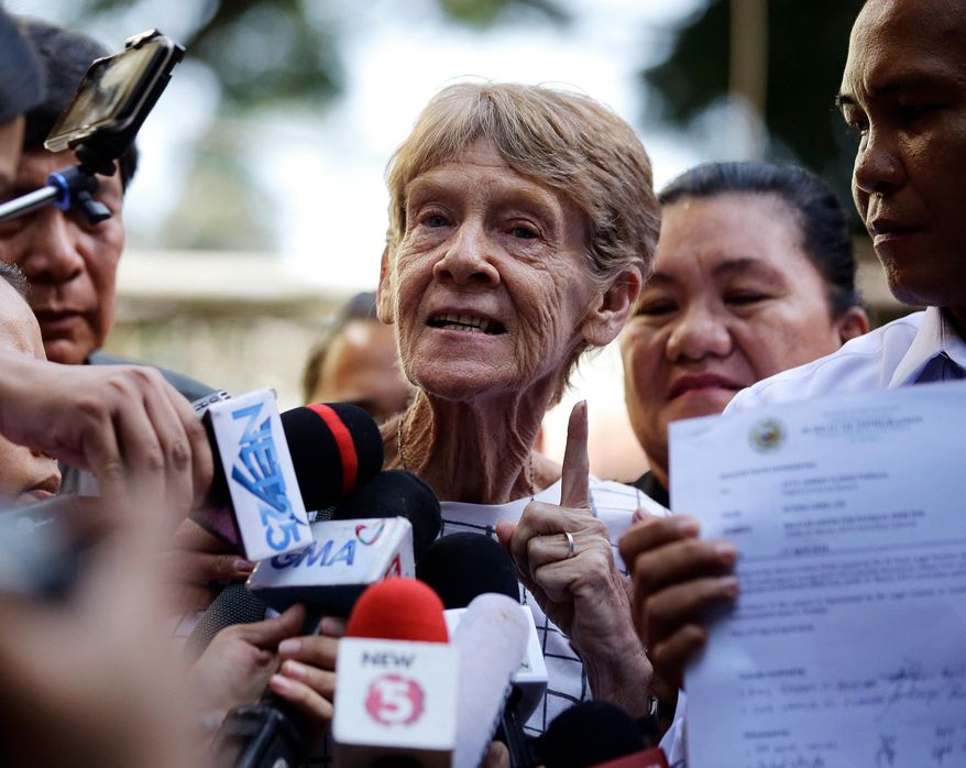 FILE - In this April 17, 2018, file photo, Australian missionary Sister Patricia Fox gestures as she is interviewed by reporters after she was released from custody at the Bureau of Immigration in Manila, Philippines. The Philippines on Wednesday, April 25, 2018 cancelled Fox's missionary visa for engaging in political activity and gave her 30 days to leave the country. (AP Photo/Aaron Favila, File)