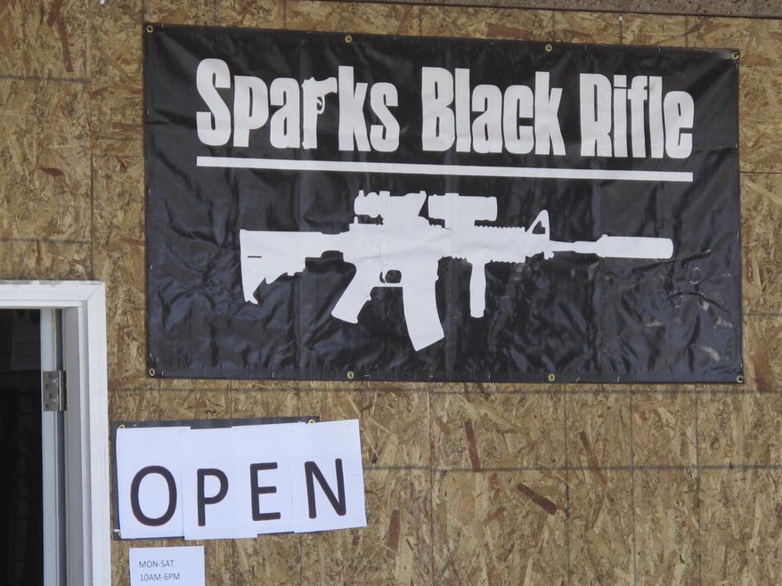 The Sparks Black Rifle gun store is pictured in this photo taken Wednesday, April 25, 2018 in Sparks, Nevada. The store's emblem was on one of two t-shirts worn by an 8th grade student who has filed a lawsuit in federal court in neighboring Reno alleging the Washoe County School District violated his constitutional rights when he was disciplined for wearing pro-gun attire in violation of the district's dress code. The front of the store has been boarded up since thieves drove a car through the glass entry way and made off with weapons. (AP Photo/By Scott Sonner).