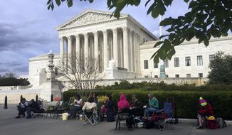 In this April 23, 2018, photo, people wait in line outside the Supreme Court in Washington, to be in the gallery when the court hears arguments in on April 25, over President Donald Trump’s ban on travelers from several mostly Muslim countries. (AP Photo/Jessica Gresko)