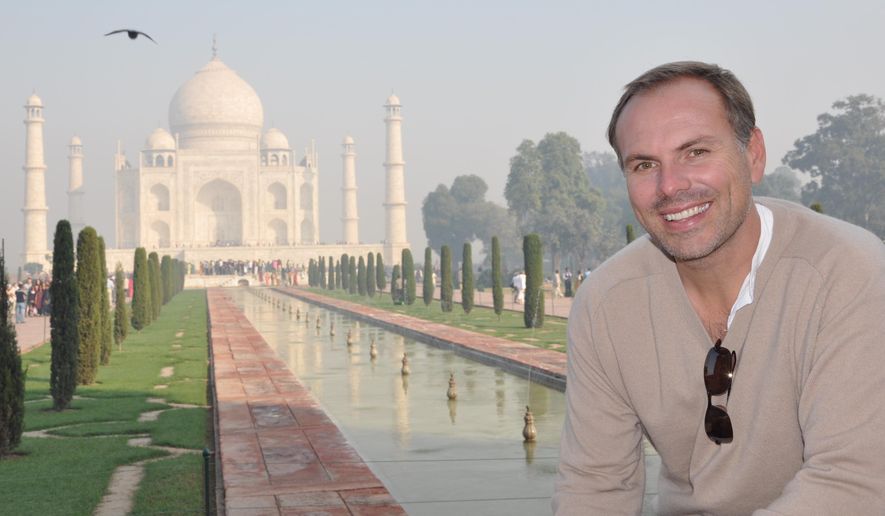 This undated photo shows John DiScala, better known as the air travel expert Johnny Jet, at the Taj Mahal in Agra, India. DiScala offered tips and strategies for booking flights and getting the best deals for summer travel in an interview with the AP Travel podcast &amp;quot;Get Outta Here!&amp;quot; airing Wednesday, April 25. (Natalie DiScala via AP)