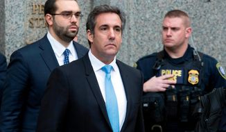 FILE - In this April 16, 2018, file photo, Michael Cohen, President Donald Trump&#39;s personal attorney, center, leaves federal court, in New York. A New York judge wants more information from prosecutors and lawyers for President Donald Trump and personal attorney Cohen to help speedily analyze materials seized from Cohen. U.S. District Judge Kimba Wood set a hearing for Thursday, April 26. (AP Photo/Mary Altaffer, File)