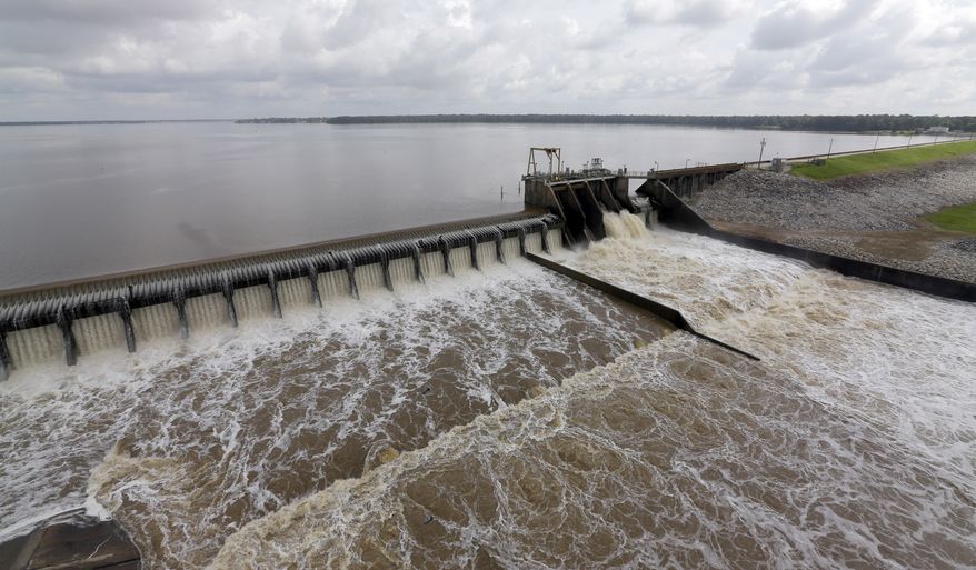 Water flows over the spillway from Lake Houston into the San Jacinto River Saturday, May 30, 2015, in Houston. The Colorado River in Wharton and the Brazos and San Jacinto rivers near Houston are the main focus of concern as floodwaters moved from North and Central Texas downstream toward the Gulf of Mexico. (AP Photo/David J. Phillip)