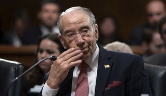 Amid President Donald Trump&#x27;s repeated criticism of special counsel Robert Mueller&#x27;s Russia investigation, Senate Judiciary Committee Chairman Chuck Grassley, R-Iowa, works on a bipartisan bill to protect the special counsel should Trump try to fire him, on Capitol Hill in Washington, Thursday, April 26, 2018. The Special Counsel Independence and Integrity Act passed 14-7 but Senate Majority Leader Mitch McConnell has insisted he will not hold a full Senate vote on the legislation. (AP Photo/J. Scott Applewhite) ** FILE **