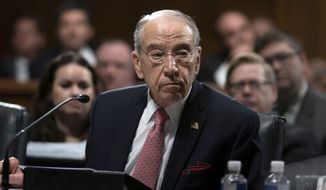 Amid President Donald Trump&#39;s repeated criticism of special counsel Robert Mueller&#39;s Russia investigation, Senate Judiciary Committee Chairman Chuck Grassley, R-Iowa, works on a bipartisan bill to protect the special counsel should Trump try to fire him, on Capitol Hill in Washington, Thursday, April 26, 2018. The Special Counsel Independence and Integrity Act passed 14-7 but Senate Majority Leader Mitch McConnell has insisted he will not hold a full Senate vote on the legislation. (AP Photo/J. Scott Applewhite)