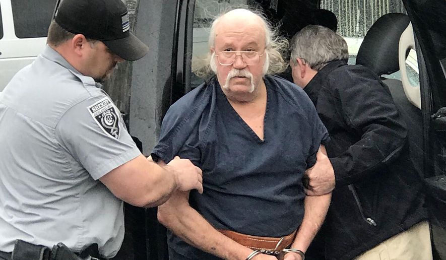 Ronnie Dean Busick arrives at the Craig County Jail in Vinita, Okla., on Wednesday, April 25, 2018. Busick was charged Monday with four counts of first-degree murder in the killing of Danny and Kathy Freeman of Craig County, and the disappearance of teenagers Lauria Bible and Ashley Freeman. Oklahoma officials say two other suspects have died. (Sheila Stogsdill /Tulsa World via AP)