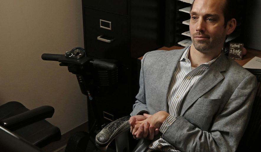 In this March 29, 2018 photo, Ryan Jansen is seen during an interview in his office at John Wood Community College in Quincy, Ill. Jansen was on track to go to West Point and eyeing a military career when a hard hit during a particularly hot football practice shattered those  dreams. He has spent the years since he suffered a traumatic brain injury pushing against his physical limitations to build a life resembling the one he had imagined as a teenager. The circumstances of his life have shifted well beyond anything he could have expected, but the core is the same, he has regained the use of his extremities, is employed full-time, owns his own home and even drives. | H-W Photo/Jake Shane (Jake Shane/The Quincy Herald-Whig via AP)