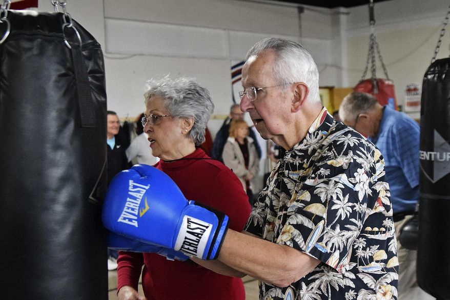 In this April 14, 2018, photo, Melvin Siverly hits the bag during the Rock Steady Boxing workout at the Weinberg Arcade in Galesburg, Ill. The class helps build strength, coordination and balance for people with Parkinson&#39;s disease. (Bill Nice/The Register-Mail via AP)