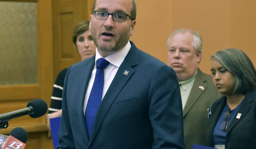 Chad Griffin, president of the Washington-based Human Rights Campaign, the nation's largest LBGTQ-rights group, speaks to reporters during a news conference, Thursday, April 26, 2018, at the Statehouse, in Topeka, Kan. The group opposes legislation that would allow the state to do business with faith-based adoption agencies that refuse for religious reasons to place children in LGBT homes. (AP Photo/Mitchell Willetts)
