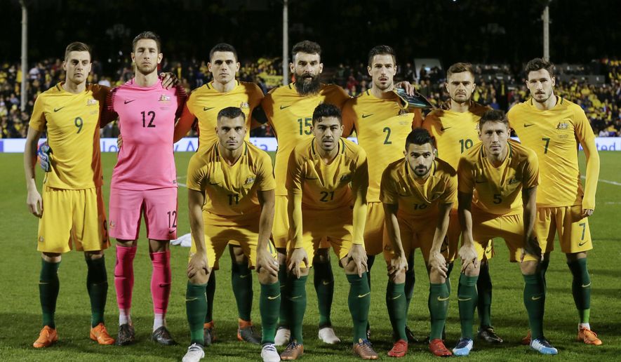 FILE - In this Tuesday, March 27, 2018 file photo, Australia&#39;s, back row from left, Tomi Juric, Bradley Jones, Tom Rogic, Mile Jedinak, Milos Degenek, Josh Risdon, Mathew Leckie and, front left to right, Andrew Nabbout, Massimo Luongo, Aziz Behich, Mark Milligan, during the national anthems before a friendly soccer match between Colombia and Australia in London, Tuesday, March 27, 2018. (AP Photo/Tim Ireland, File)