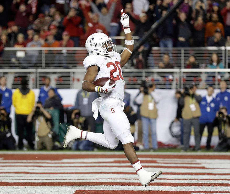 FILE - In this Dec. 1, 2017, file photo, Stanford running back Bryce Love (20) celebrates after scoring a touchdown against Southern California during the first half of the Pac-12 Conference championship NCAA college football game in Santa Clara, Calif. The Cardinal got an unexpected surprise when Love opted to return to Stanford after finishing runner-up to Oklahoma's Baker Mayfield for the 2017 Heisman Trophy. Love will be one of the favorites to win it this season. (AP Photo/Marcio Jose Sanchez, File)