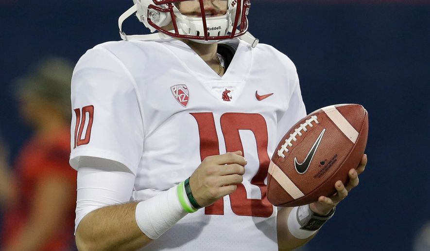 FILE - In this Oct. 28, 2017, file photo, Washington State quarterback Trey Tinsley waits for the team's NCAA college football game against Arizona in Tucson, Ariz. After years of enjoying the record-setting exploits of quarterback Luke Falk, Washington State faces big questions looking toward next season. Falk has graduated, and that leaves the Cougars searching for a starter among players who haven’t thrown a pass in an actual game. Six quarterbacks took snaps last Saturday in Spokane during the Cougars’ annual Crimson and Gray scrimmage. Coach Mike Leach was far from expansive about what he saw from the starters, juniors Tinsley and Anthony Gordon. (AP Photo/Rick Scuteri, File)