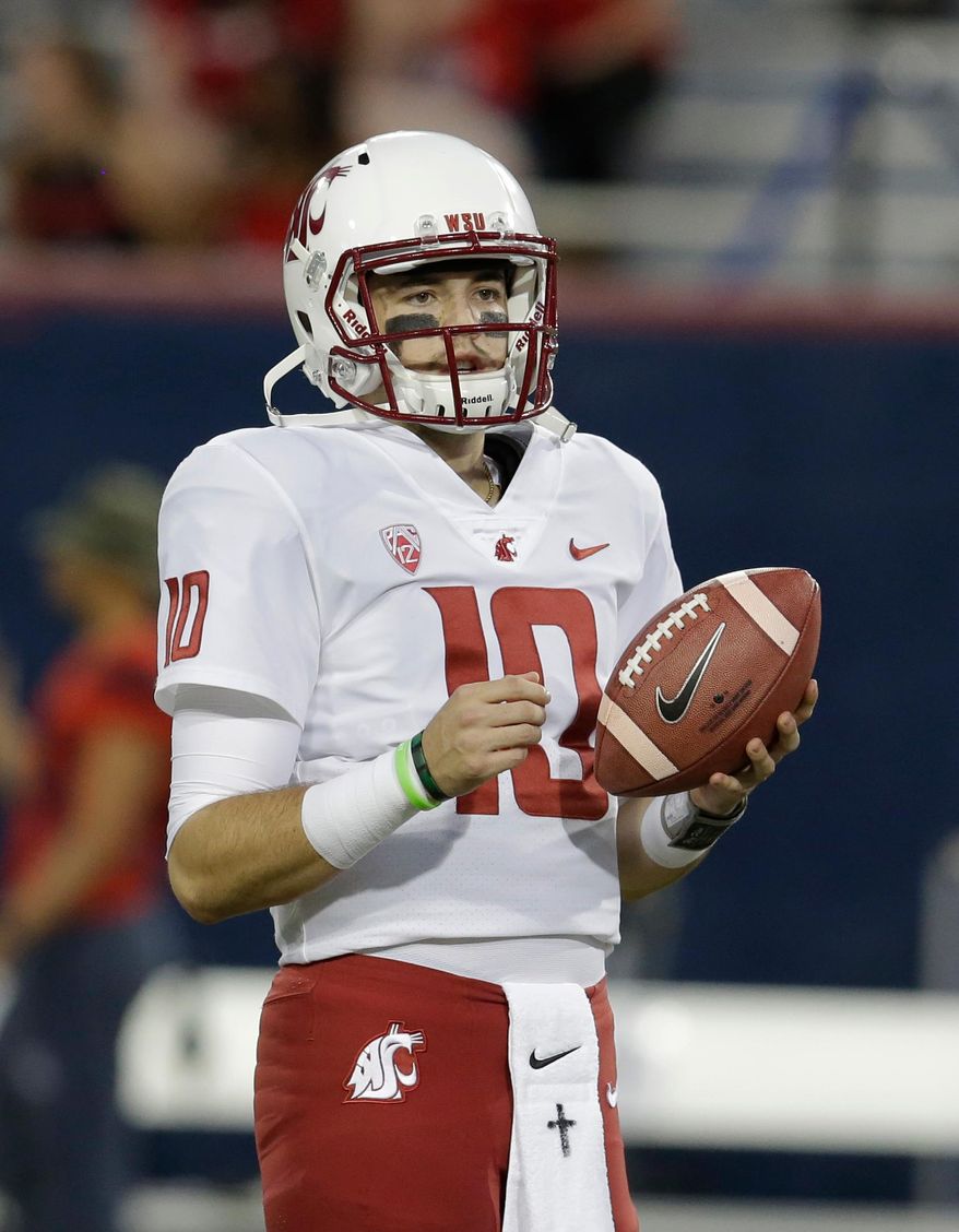 FILE - In this Oct. 28, 2017, file photo, Washington State quarterback Trey Tinsley waits for the team's NCAA college football game against Arizona in Tucson, Ariz. After years of enjoying the record-setting exploits of quarterback Luke Falk, Washington State faces big questions looking toward next season. Falk has graduated, and that leaves the Cougars searching for a starter among players who haven’t thrown a pass in an actual game. Six quarterbacks took snaps last Saturday in Spokane during the Cougars’ annual Crimson and Gray scrimmage. Coach Mike Leach was far from expansive about what he saw from the starters, juniors Tinsley and Anthony Gordon. (AP Photo/Rick Scuteri, File)