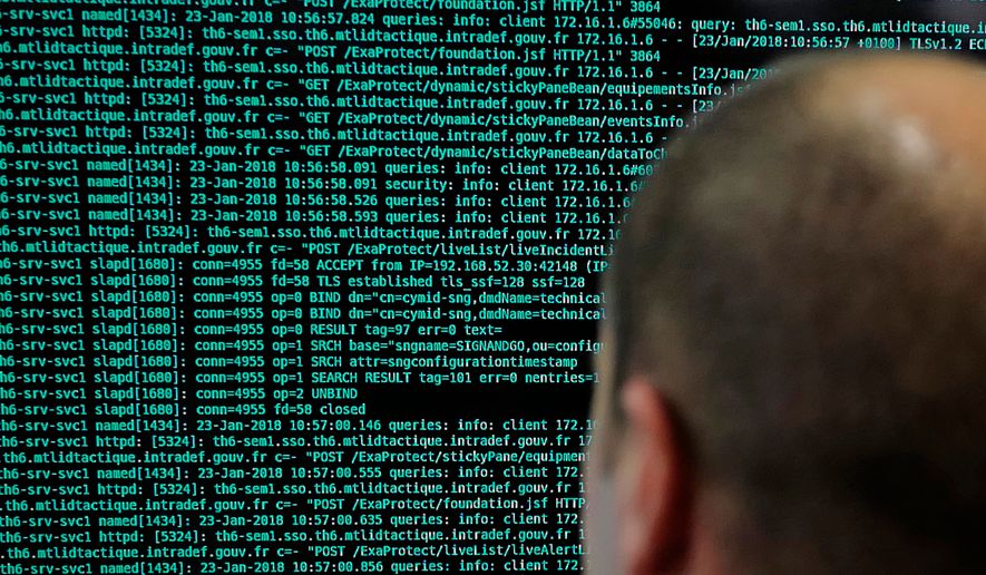 In this Jan.23 2018 file photo, a French solider watches code lines on his computer at the French Defense ministry stand during the International Cybersecurity forum in Lille, northern France. (AP Photo/Michel Spingler, File)