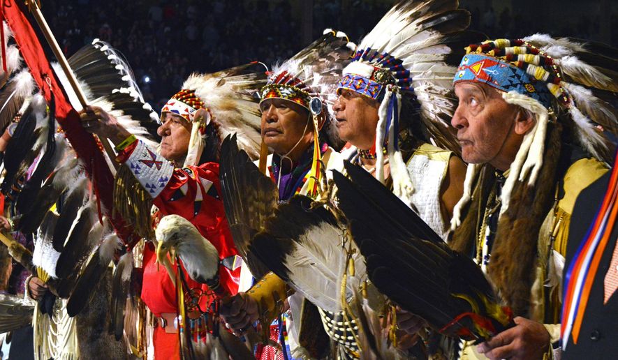 FILE--In this April 28, 2017 file photo, a group of Native American elders lead the grand entry to the Gathering of Nations in Albuquerque, N.M. The Gathering of Nations, one of the world&#39;s largest gatherings of indigenous people, is set to begin Friday, April 27, 2018, in Albuquerque, drawing around 3,000 dancers from hundreds of tribes in the U.S., Canada and Mexico and generally pulling in about 80,000 visitors with dances, drum contests and various competitions. (AP Photo/Russell Contreras, file)