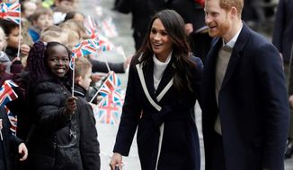 FILE - In this Thursday, March 8, 2018 file photo, Britain&#39;s Prince Harry and his fiance Meghan Markle are greeted by flag waving school children as they arrive to take part in an event for young women as part of International Women&#39;s Day in Birmingham, central England. Kensington Palace says the California-born Markle intends to take U.K. citizenship after she marries Harry on May 19 at Windsor Castle. (AP Photo/Matt Dunham, File)