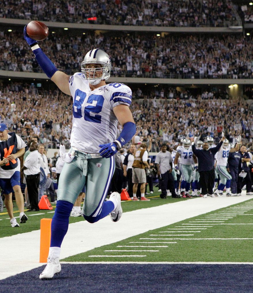 FILE - In this Oct. 25, 2010, file photo, Dallas Cowboys tight end Jason Witten holds the ball up as he scores a 4-yard touchdown against the New York Giants during the first quarter of an NFL football game, in Arlington, Texas. Witten plans to retire after 15 seasons and join ESPN as its lead analyst for the &amp;quot;Monday Night Football&amp;quot; broadcast, the network reported Friday, April 27, 2018.(AP Photo/LM Otero, File) **FILE**
