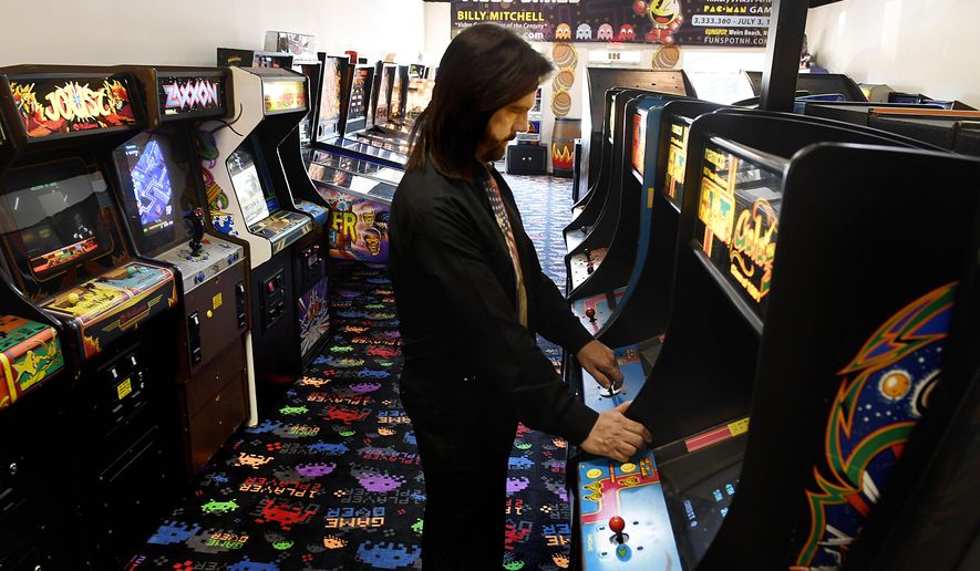 ADVANCE FOR WEEKEND EDITIONS, APRIL 28-29 - In this March 22, 2018 photo, Billy Mitchell, a competitive gamer who lives in Hollywood, Fla.,  plays at Arcade Game Sale in Fort Lauderdale, Fla. Mitchell, once declared the Video Game Player of the Century, is now facing the ultimate test of his skills: salvaging his reputation. Twin Galaxies, competitive gaming&#39;s governing body, found him guilty of cheating. (Taimy Alvarez/South Florida Sun-Sentinel via AP)