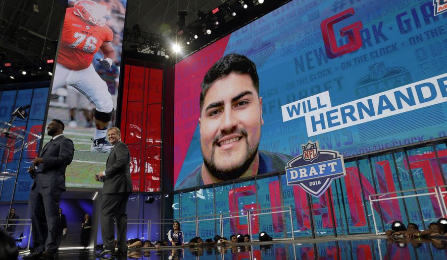 Former New York Giants player Justin Tuck, left, makes his team&#39;s selection as NFL Commissioner Roger Goodell, right, applauds during the second round of the NFL football draft Friday, April 27, 2018, in Arlington, Texas. The Giants selected UTEP&#39;s Will Hernandez. (AP Photo/Eric Gay)