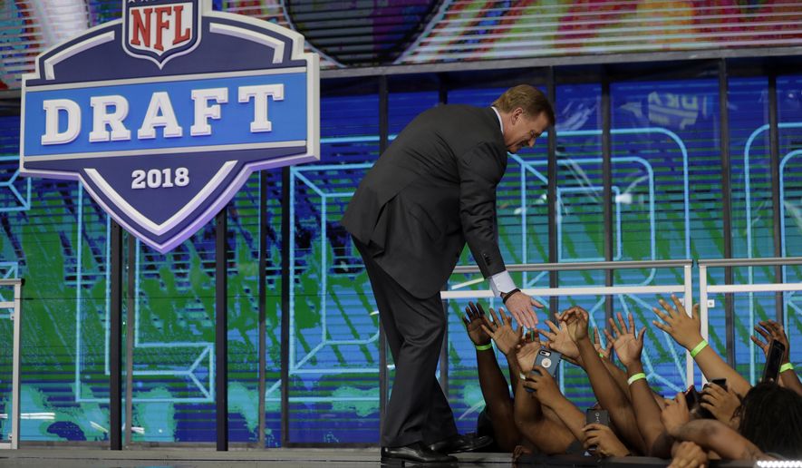 NFL Commissioner Roger Goodell greets fans from the stage during the second round of the NFL football draft Friday, April 27, 2018, in Arlington, Texas. (AP Photo/Eric Gay)