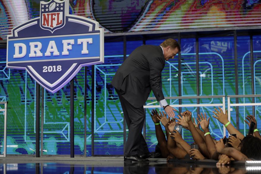 NFL Commissioner Roger Goodell greets fans from the stage during the second round of the NFL football draft Friday, April 27, 2018, in Arlington, Texas. (AP Photo/Eric Gay)